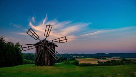 Hilltop Wooden Windmill Over Quiet Grasslands at Dusk in 4K wallpaper