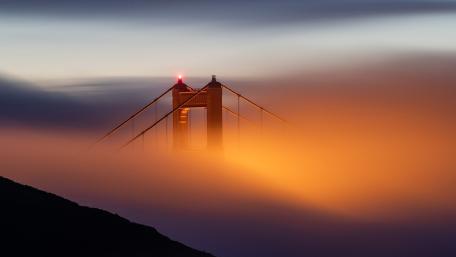 Golden Gate Bridge Emerging Through Fog at Dusk in San Francisco wallpaper