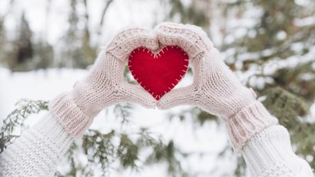 Warm Winter Love Hands Framing a Bright Red Heart wallpaper