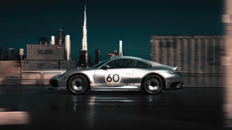 Porsche 911 Speeding Through Neon City Night in Crisp 4K wallpaper