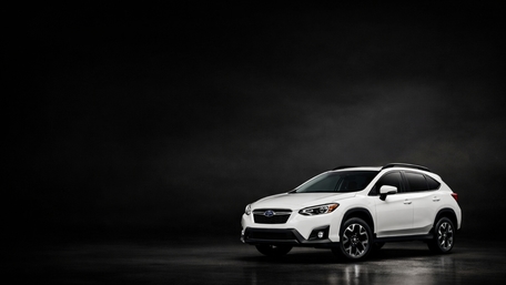 White Subaru XV Spotlighted in Deep Shadow Studio Scene wallpaper