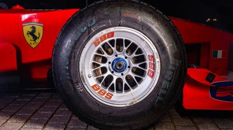 Formula Racing Close Up Tire and Wheel Under Pit Lights wallpaper