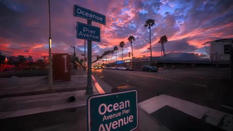 Orange-pink sunset paints the west coast wallpaper