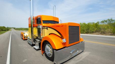 Custom Orange Peterbilt 379 Semi Truck on Open Highway 4K Wallpaper wallpaper