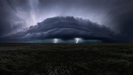 Massive Shelf Cloud Unleashing Lightning Over Prairie at Dusk wallpaper