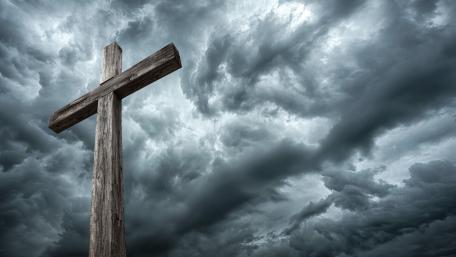 Weathered Cross Against Stormy Heaven in Cinematic Nature Light wallpaper