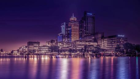 Purple Night Reflections on the Amstel River in Amsterdam wallpaper