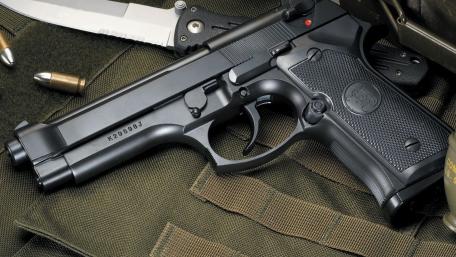 Beretta M9 Tactical Sidearm Closeup on Field Gear wallpaper