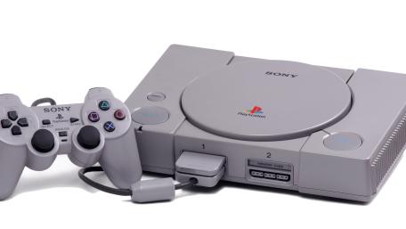Classic PlayStation Console and Controller on Clean White Background wallpaper