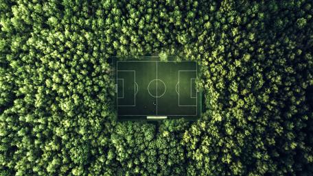 Hidden Forest Football Pitch From Above In Lush 5K Green wallpaper
