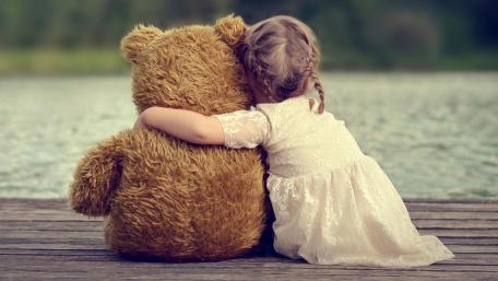 Gentle Childhood Hug by the Lake with a Beloved Teddy Bear wallpaper