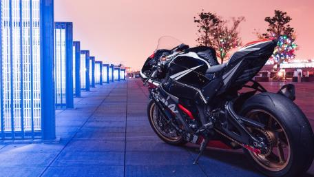 Kawasaki Ninja Supersport Silhouette Under Neon Blue City Lights wallpaper