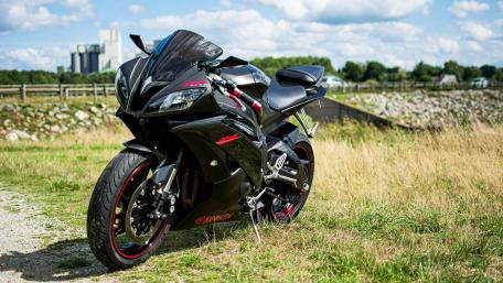 Sleek Yamaha Sport Motorcycle in Sunlit Meadow Landscape wallpaper