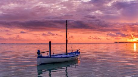 Silent Boat at Blazing Sunset Horizon Over Glassy Sea wallpaper