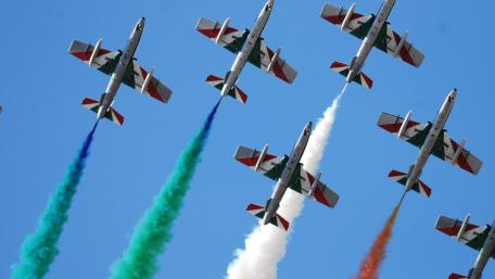 Tricolor Aerobatic Jets in Precision Formation Over Clear Blue Sky wallpaper