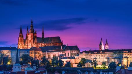 Prague Castle Illuminated at Dusk Over the Historic City Skyline wallpaper