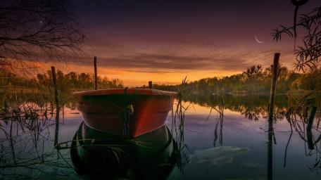 Afterglow Drift Boat at Dusk on a Quiet Lake wallpaper