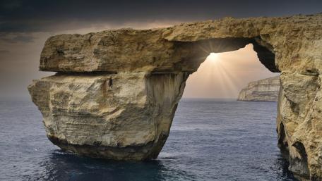 Sunbeams Through Malta’s Azure Window Natural Arch Over the Sea wallpaper