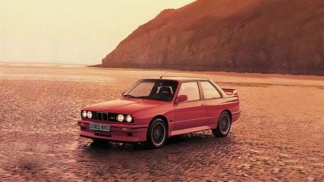 Classic BMW Coupe on Golden Beach at Sunset Serenity wallpaper