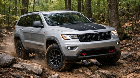Jeep Grand Cherokee Charging Through Rugged Forest Trail Adventure wallpaper