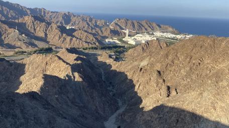 Sunlit Rocky Valleys and Coastal Peaks of Muscat Oman wallpaper