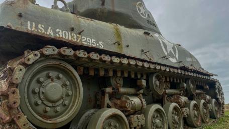 Weathered Sherman Tank Tracks Under Brooding Skies in 4K wallpaper