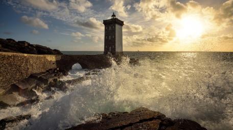 Stormlit Sunset at Kermorvan Lighthouse on the Brittany Coast wallpaper