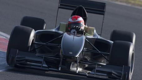 Head On Formula One Racing Car Charging Through The Corner wallpaper