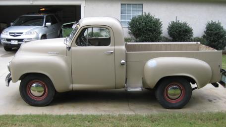 Vintage Beige Pickup Truck Parked in a Quiet Suburban Driveway wallpaper