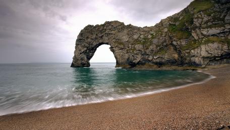 Durdle Door Natural Arch Over Calm Jurassic Coast Waters wallpaper