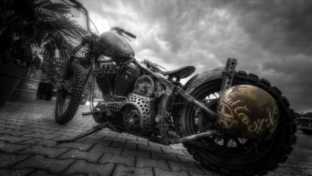 Gritty Monochrome Custom Motorcycle Under Stormy Skies wallpaper