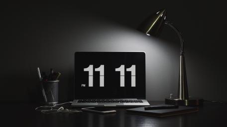 Monochrome Laptop Desk Setup with 11 11 Flip Clock Glow wallpaper