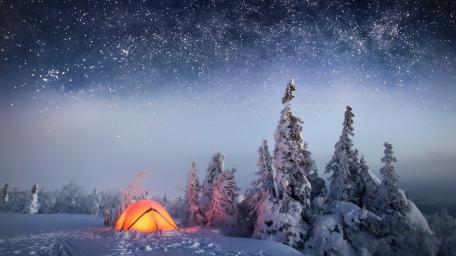 Glowing Winter Tent Beneath a Vast Starry Sky wallpaper