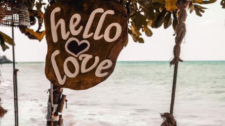 Hello Love Beach Sign by the Sea in Warm Tropical Light wallpaper