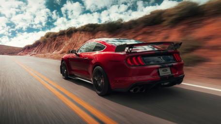 Red Shelby GT500 Mustang Racing the Open Highway in 4K wallpaper