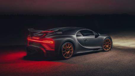 Bugatti Chiron Night Stance with Glowing Taillights and Bronze Wheels wallpaper