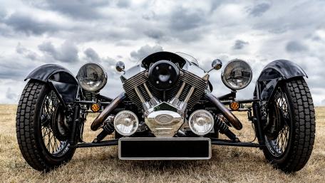 Morgan 3 Wheeler Front View Under Dramatic Cloudy Skies wallpaper