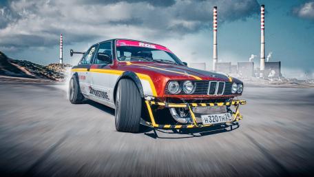BMW E-Series Drift Car Charging Through Industrial Skyline in 5K wallpaper