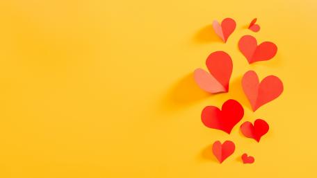 Floating Red Paper Hearts on Bright Yellow Romantic 5K Background wallpaper