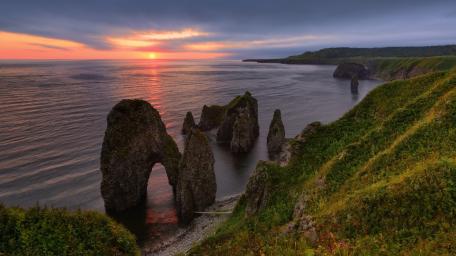 Sunset Seastacks and Rugged Cliffs on Iturup Island Coast wallpaper