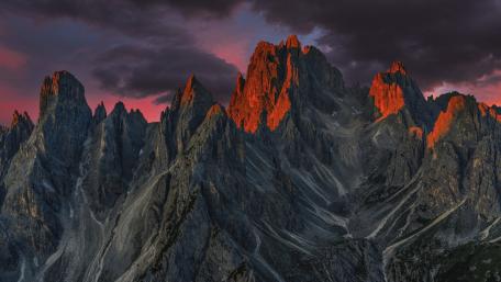 Crimson Sunset Over Tre Cime di Lavaredo Dolomite Peaks wallpaper