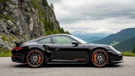 Black Porsche 911 Turbo S on Alpine Mountain Road 4K Wallpaper wallpaper