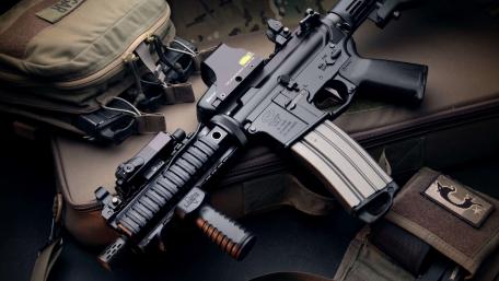 Tactical M4 Carbine Close Up on Rugged Field Gear wallpaper