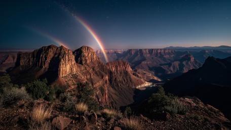 Starlit Double Rainbow Over Grand Canyon Cliffs in Arizona wallpaper