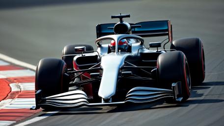 4K Formula One Race Car Charging Through a Tight Corner wallpaper