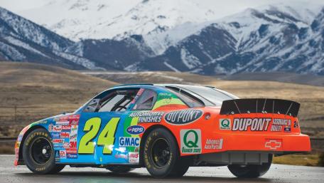 DuPont Number 24 Stock Car Power Against Snowcapped Mountain Backdrop wallpaper