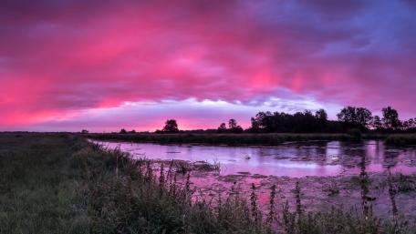 Pink Dawn Over a Quiet River and Riparian Meadows wallpaper