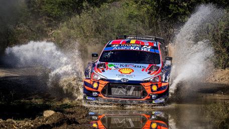 Hyundai WRC Rally Car Charging Through Water Splash at Full Speed wallpaper