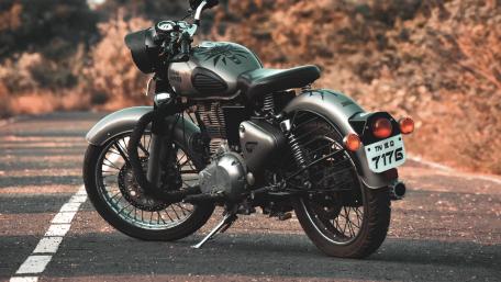 Royal Enfield Classic Motorcycle Waiting on a Quiet Road wallpaper