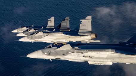 Saab JAS 39 Gripen Formation Over Open Sea Skies wallpaper